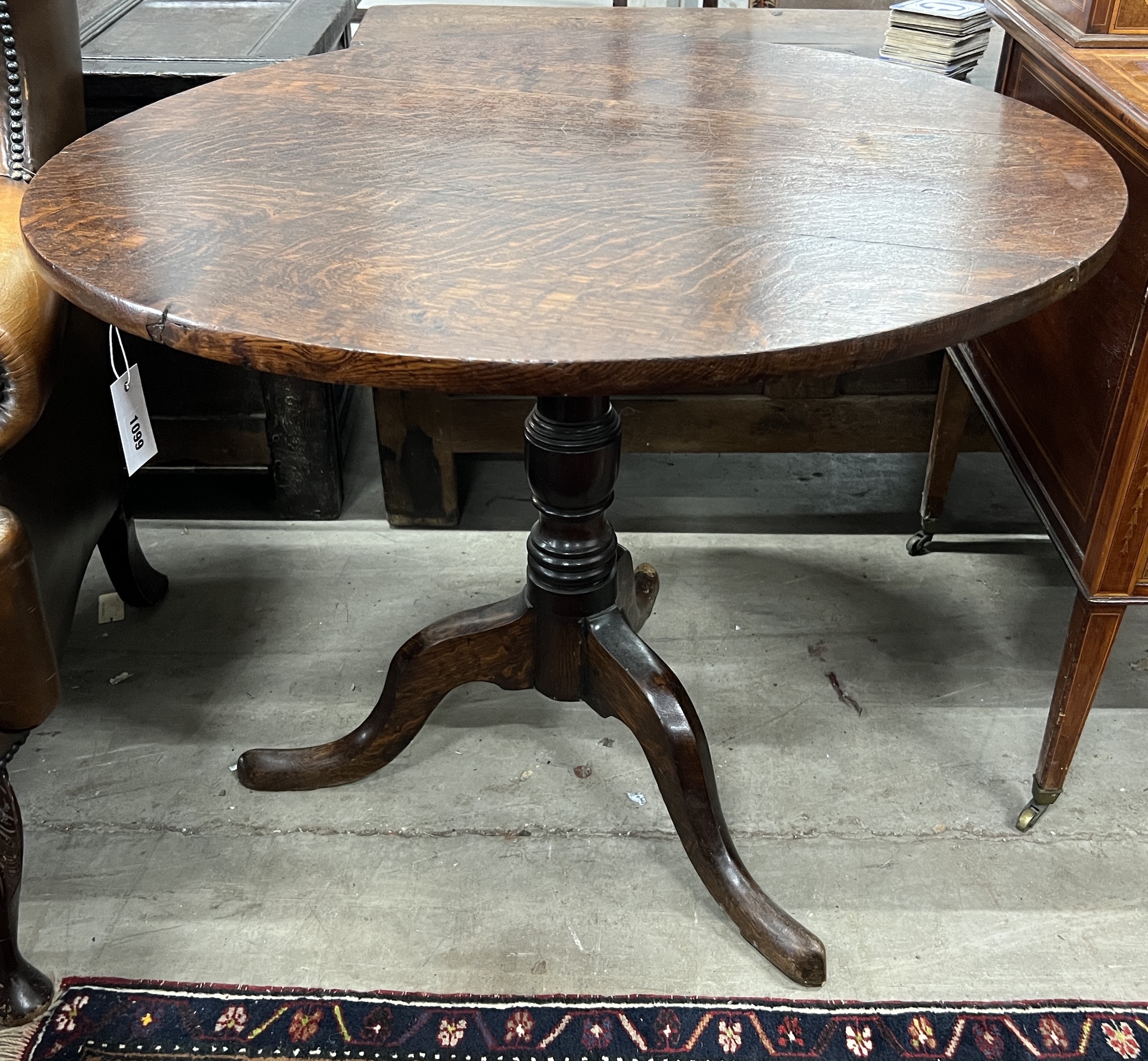 A George III circular oak tilt top tea table, diameter 87cm, height 69cm